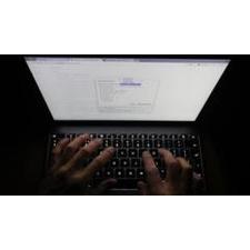 A man looks at the settings on his laptop's Chrome browser